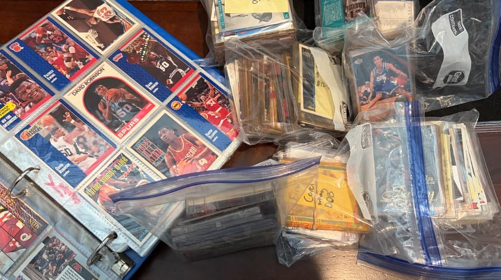 Unsorted card collection — binders, bags, and mixed cards